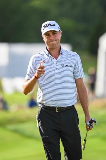 Justin Thomas waves his ball to fans after making a birdie putt on the 17th hole green during the first round of THE NORTHERN TRUST, the first event...