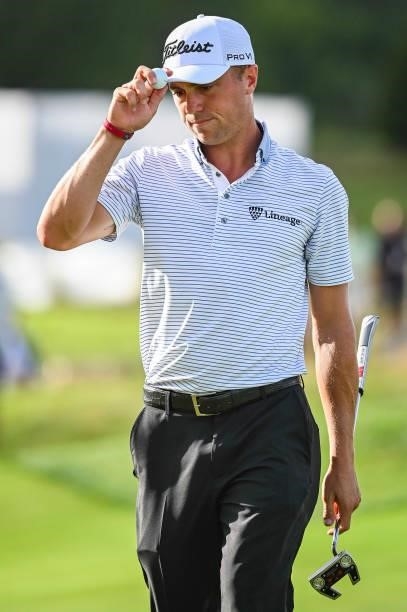 Justin Thomas tips his cap to fans after making a birdie putt on the 17th hole green during the first round of THE NORTHERN TRUST, the first event of...