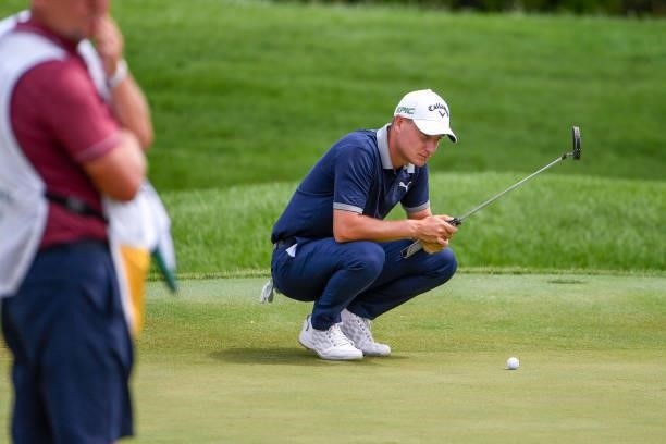 Emiliano Grillo of Argentina lines up his putt at the eighth hole during the first round of THE NORTHERN TRUST at Liberty National Golf Club on...