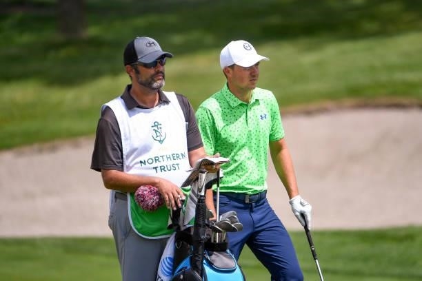 Jordan Spieth and caddie Michael Greller talk over their shot at the eighth hole during the first round of THE NORTHERN TRUST at Liberty National...
