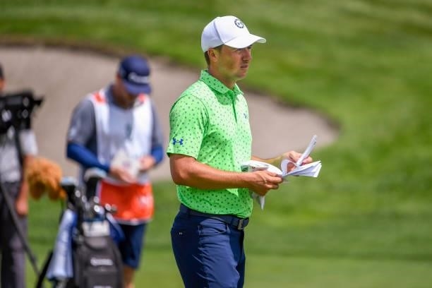 Jordan Spieth looks over his yardage book at the eighth hole during the first round of THE NORTHERN TRUST at Liberty National Golf Club on August 19,...