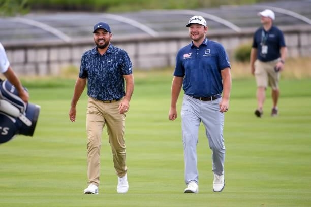 Jason Day of Australia and Matthew NeSmith laugh and talk in the 18th fairway during the first round of THE NORTHERN TRUST at Liberty National Golf...