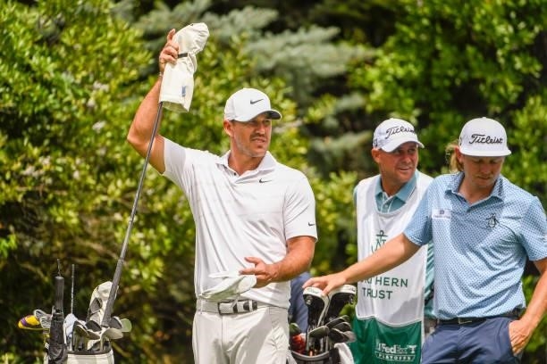 Brooks Koepka pulls a club at the ninth tee during the first round of THE NORTHERN TRUST at Liberty National Golf Club on August 19, 2021 in Jersey...