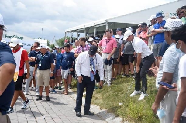 Rory McIlroy gets a ruling on the 18th fairway during the first round of THE NORTHERN TRUST at Liberty National Golf Club on August 19, 2021 in...