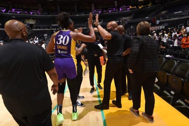 Head Coach Derek Fisher of the Los Angeles Sparks high fives Nneka Ogwumike of the Los Angeles Sparks after the game against the Atlanta Dream on...