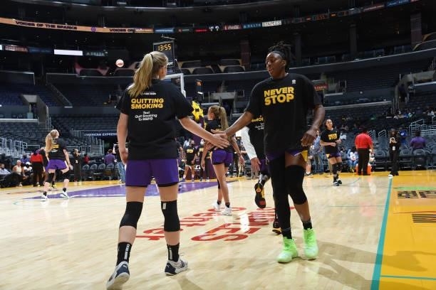 Nneka Ogwumike high fives Karlie Samuelson of the Los Angeles Sparks before the game against the Atlanta Dream on August 19, 2021 at the Staples...