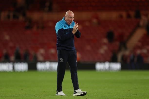 Queens Park Rangers manager Mark Warburton celebrates in front of their fans after during the Sky Bet Championship match between Middlesbrough and...