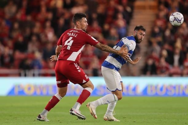 Charlie Austin of Queens Park Rangers in action with Middlesbrough's Grant Hall during the Sky Bet Championship match between Middlesbrough and...