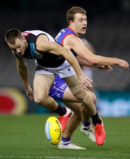 Robbie Gray of the Power and Jack Macrae of the Bulldogs in action during the 2021 AFL Round 23 match between the Western Bulldogs and the Port...