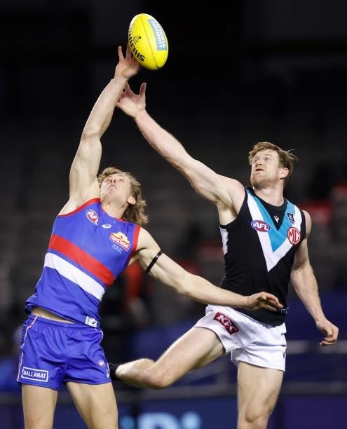 Aaron Naughton of the Bulldogs and Tom Jonas of the Power during the 2021 AFL Round 23 match between the Western Bulldogs and the Port Adelaide Power...