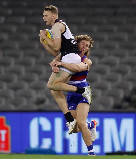 Trent McKenzie of the Power and Aaron Naughton of the Bulldogs compete for the ball during the 2021 AFL Round 23 match between the Western Bulldogs...