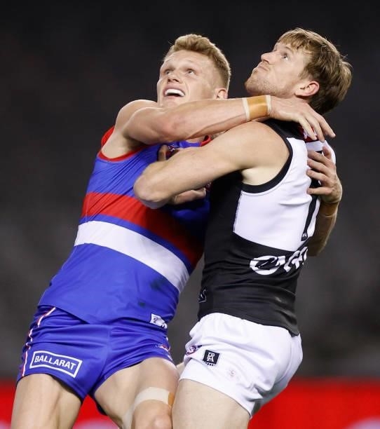 Adam Treloar of the Bulldogs and Tom Jonas of the Power compete for the ball during the 2021 AFL Round 23 match between the Western Bulldogs and the...