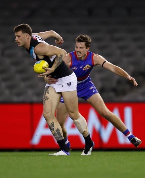 Peter Ladhams is tackled by Zaine Cordy of the Bulldogs during the 2021 AFL Round 23 match between the Western Bulldogs and the Port Adelaide Power...