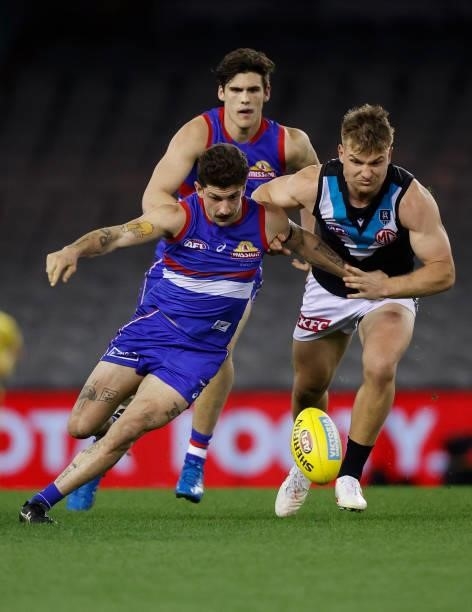 Tom Liberatore of the Bulldogs and Ollie Wines of the Power compete for the ball during the 2021 AFL Round 23 match between the Western Bulldogs and...