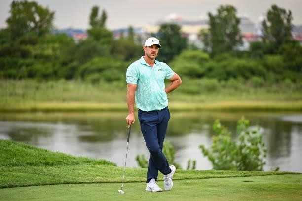 Brooks Koepka stands on the 18th hole green during the second round of THE NORTHERN TRUST, the first event of the FedExCup Playoffs, at Liberty...