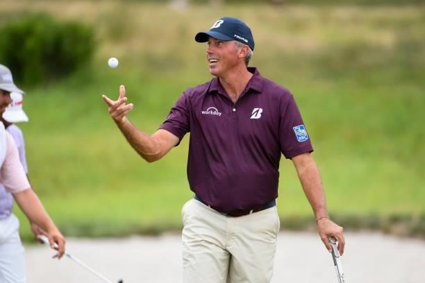 Matt Kuchar tosses his golf ball to his caddie at the second hole during the second round of THE NORTHERN TRUST at Liberty National Golf Club on...