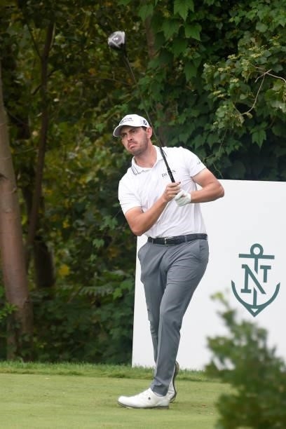 Patrick Cantlay watches his tee shot on the 18th hole during the second round of THE NORTHERN TRUST at Liberty National Golf Club on August 20, 2021...