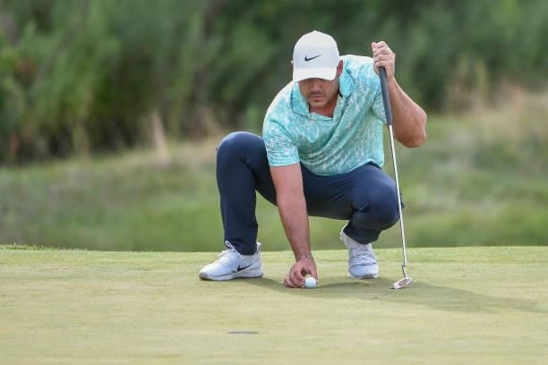 Brooks Koepka lines up his putt at the 17th green during the second round of THE NORTHERN TRUST at Liberty National Golf Club on August 20, 2021 in...