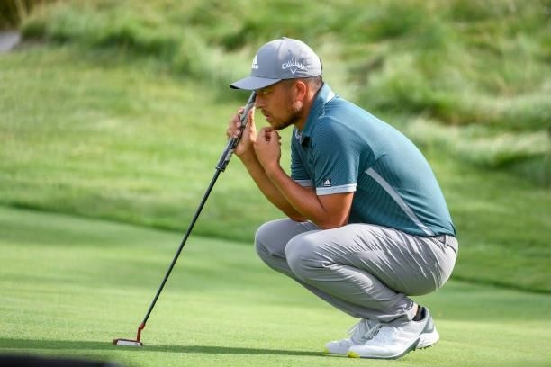 Xander Schauffele waits to putt at the 15th green during the second round of THE NORTHERN TRUST at Liberty National Golf Club on August 20, 2021 in...