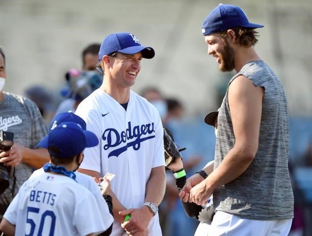 Former New Orleans Saints quarter back Drew Brees and his son visit with pitcher Clayton Kershaw of the Los Angeles Dodgers prior to the start of a...