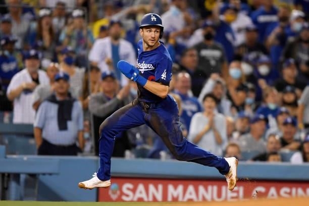 Trea Turner of the Los Angeles Dodgers flies around third base on his way to score a run on a double by Max Muncy during the third inning against the...