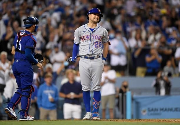Davis of the New York Mets reacts after striking out with the bases loaded for the last out of the eight inning against relief pitcher Alex Vesia of...