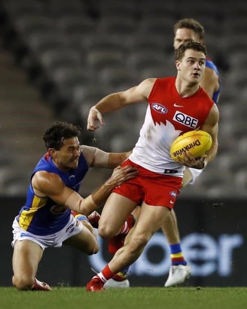 Tom Papley of the Swans is tackled by Jarrod Harbrow of the Suns during the 2021 AFL Round 23 match between the Sydney Swans and the Gold Coast Suns...
