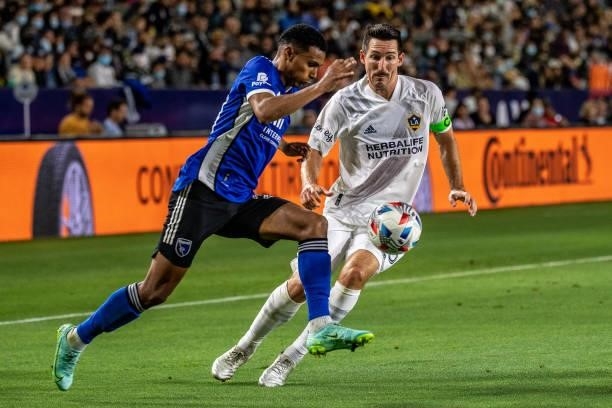 Marcos Lopez of the San Jose Earthquakes controls the ball against Sacha Kljestan of Los Angeles Galaxy during the game at the Dignity Health Sports...
