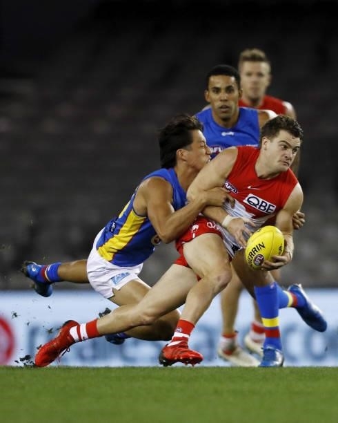 Tom Papley of the Swans is tackled by Alex Davies of the Suns during the 2021 AFL Round 23 match between the Sydney Swans and the Gold Coast Suns at...
