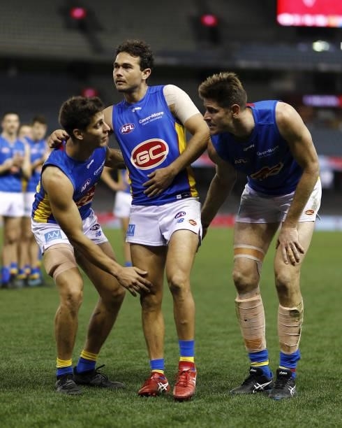 Jarrod Harbrow of the Suns is chaired off the ground by Sean Lemmens of the Suns and Zac Smith of the Suns after his final game during the 2021 AFL...
