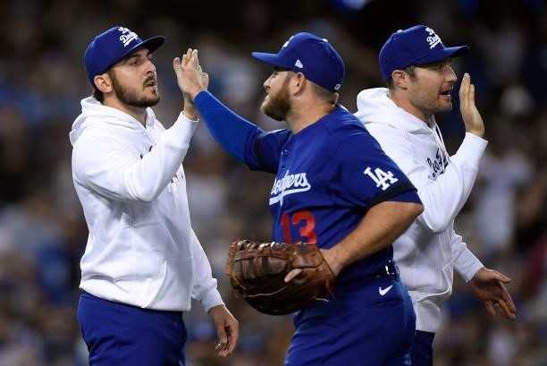 Relief pitcher Alex Vesia of the Los Angeles Dodgers who came in the eighth inning to stop the New York Mets rally is congratulated by Max Muncy...