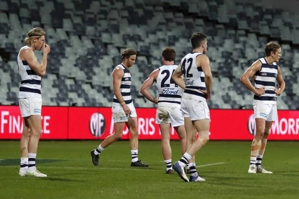 Geelong Cats players look dejected after a loss during the 2021 AFL Round 23 match between the Geelong Cats and the Melbourne Demons at GMHBA Stadium...