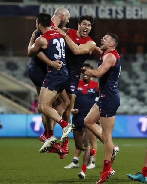 Max Gawn of the Demons celebrates a goal to win the match after the final siren with teammates Alex Neal-Bullen, Christian Petracca and Steven May...