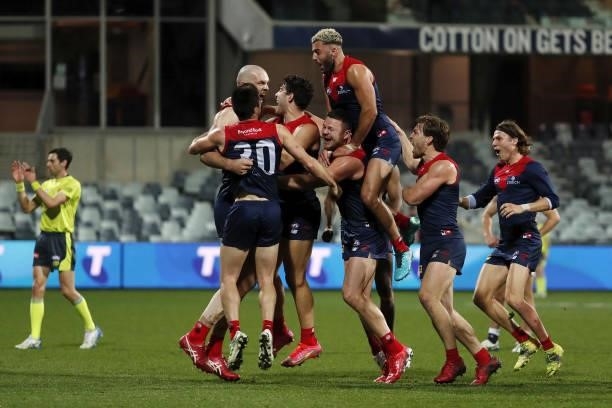 Max Gawn of the Demons celebrates a goal to win the match after the final siren with teammates during the 2021 AFL Round 23 match between the Geelong...