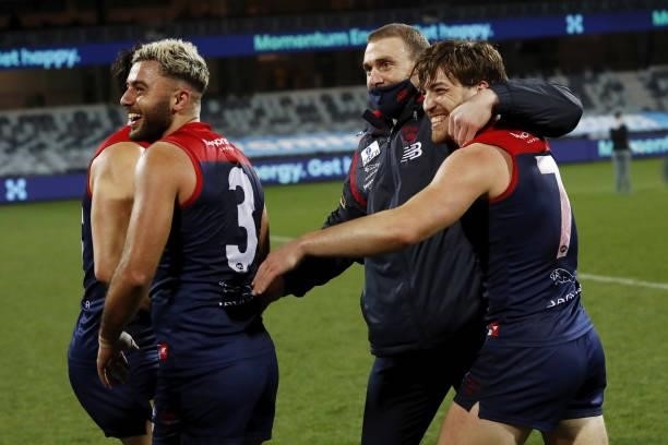 Simon Goodwin, Senior Coach of the Demons celebrates with Jack Viney of the Demons and Christian Salem of the Demons during the 2021 AFL Round 23...