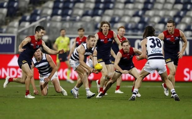 Joel Selwood of the Cats handpasses the ball during the 2021 AFL Round 23 match between the Geelong Cats and the Melbourne Demons at GMHBA Stadium on...