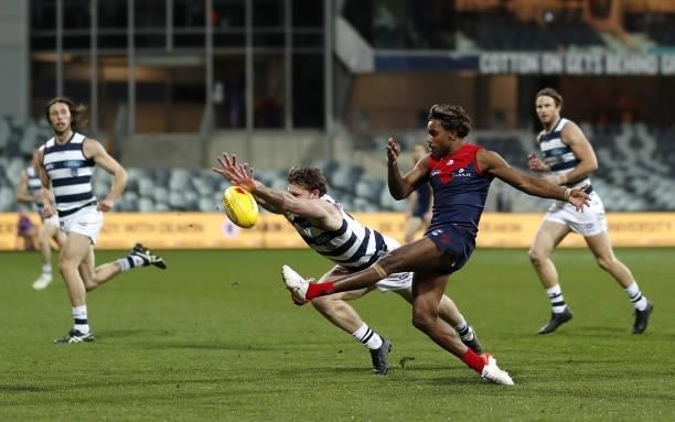 Jed Bews of the Cats smothers the kick of Kysaiah Pickett of the Demons during the 2021 AFL Round 23 match between the Geelong Cats and the Melbourne...