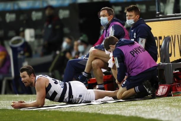 Patrick Dangerfield of the Cats receives a rub down during the 2021 AFL Round 23 match between the Geelong Cats and the Melbourne Demons at GMHBA...
