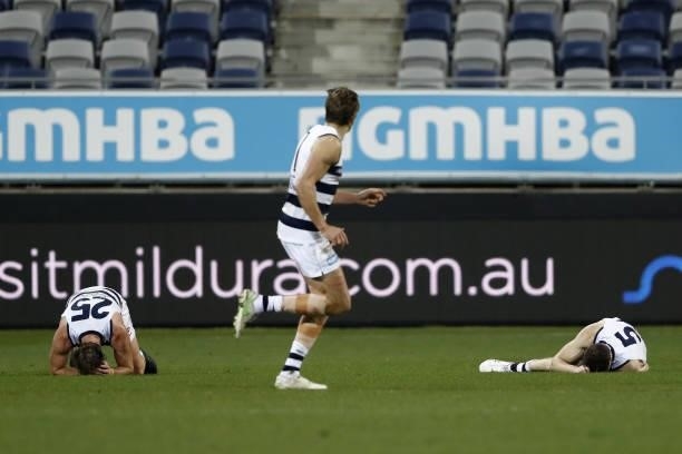 Jeremy Cameron of the Cats and Lachie Henderson of the Cats lay injured after colliding during the 2021 AFL Round 23 match between the Geelong Cats...