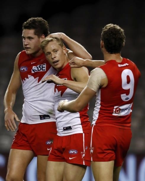 Isaac Heeney of the Swans celebrates a goal with Hayden McLean of the Swans and Will Hayward of the Swans during the 2021 AFL Round 23 match between...