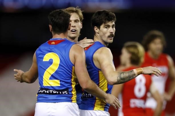 Alex Sexton of the Suns celebrates a goal with Rory Atkins of the Suns and Noah Anderson of the Suns during the 2021 AFL Round 23 match between the...