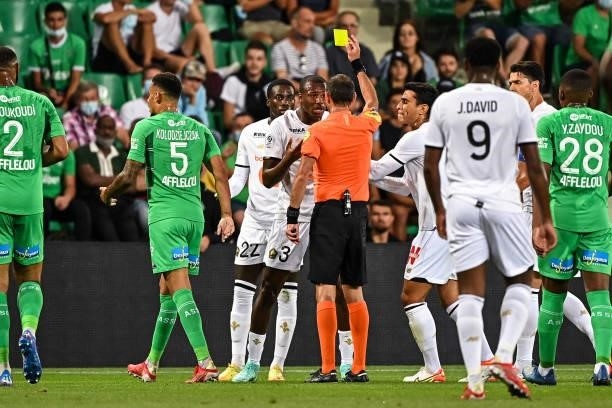 The referee shows a yellow card to Tiago DJALO of Lille during the French Ligue 1 Uber Eats soccer match between Saint Etienne and Lille at Stade...