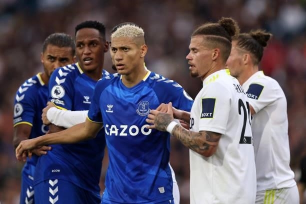 Richarlison, Yerry Mina and Dominic Calvert-Lewin of Everton tangles with Kalvin Phillips of Leeds United during the Premier League match between...