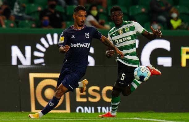 Diogo Calila of Belenenses SAD with Nuno Mendes of Sporting CP in action during the Liga Bwin match between Sporting CP and Belenenses SAD at Estadio...