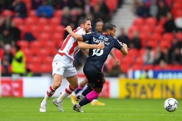 Joe Allen of Stoke City and Joao Carvalho of Nottingham Forest during the Sky Bet Championship match between Stoke City and Nottingham Forest at the...