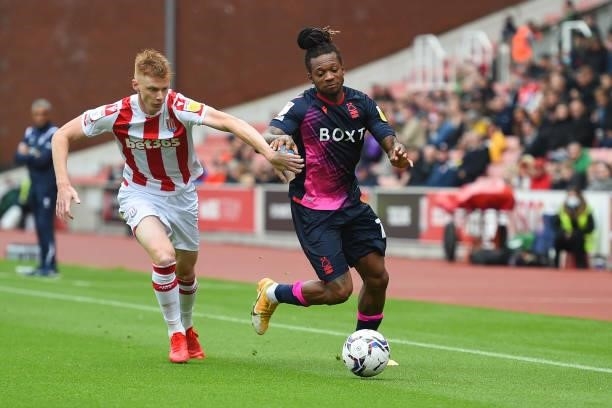 Sam Clucas of Stoke City puts pressure of Gaetan Bong of Nottingham Forest during the Sky Bet Championship match between Stoke City and Nottingham...