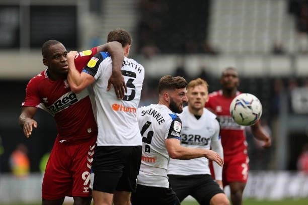 Uche Ikpeazu of Middlesbrough and Craig Forsyth of Derby County grapple in the area after a corner during the Sky Bet Championship match between...