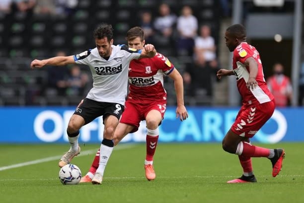 Sam Baldock of Derby County controls the ball under pressure from Paddy McNair of Middlesbrough during the Sky Bet Championship match between Derby...