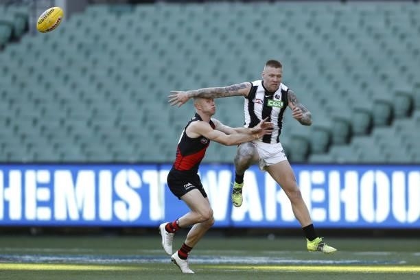 Jordan De Goey of the Magpies and Nick Hind of the Bombers compete for the ball during the 2021 AFL Round 23 match between the Essendon Bombers and...