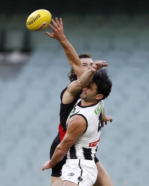 Brodie Grundy of the Magpies and Sam Draper of the Bombers compete for the ball during the 2021 AFL Round 23 match between the Essendon Bombers and...